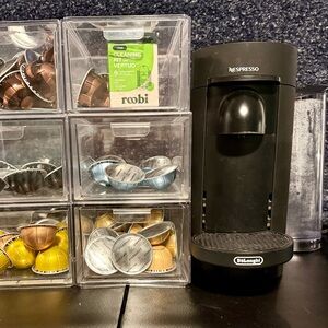 Nespresso Vertuo with pods, cleaning kit, and storage!